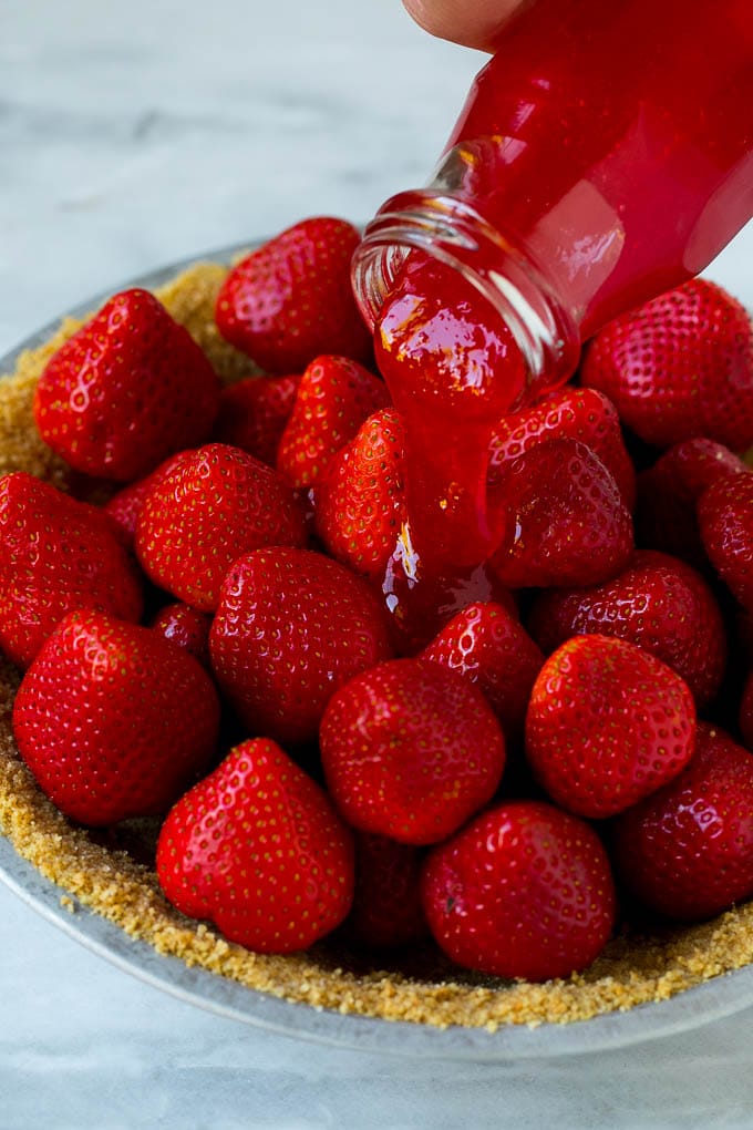 No Bake Strawberry Pie Recipe | Fresh Strawberry Pie | Strawberry Pie Recipe | No Bake Pie Recipe #strawberry #strawberrypie #nobake #nobakepie #dessert #bajap Glaze being poured over a strawberry pie.