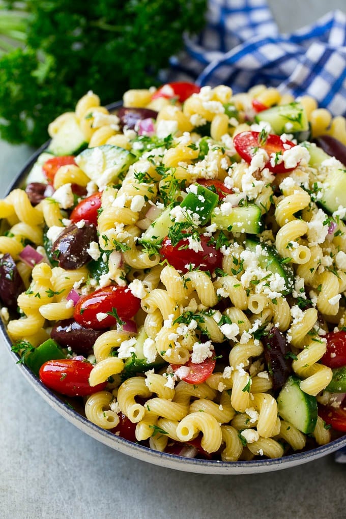 Greek Pasta Salad | Easy Pasta Salad | Vegetable Pasta Salad #pasta #salad #greek #cucumber #tomato #vegetarian #dinner #bajap Greek pasta salad in a serving bowl, garnished with parsley.