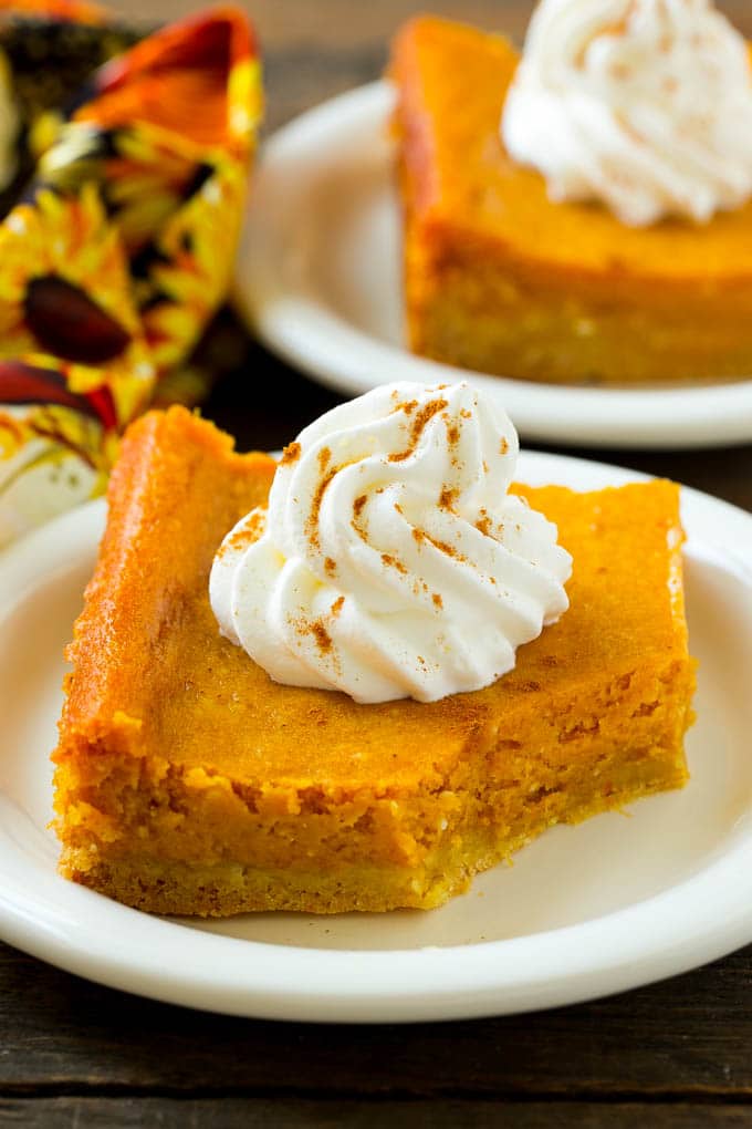 Pumpkin Gooey Butter Cake Recipe | Pumpkin Cake Recipe | Gooey Butter Cake | Pumpkin Dessert | Thanksgiving Dessert #pumpkin #cake #pumpkincake #gooeybuttercake #dessert #bajap A slice of pumpkin butter cake with a bite taken out of it.
