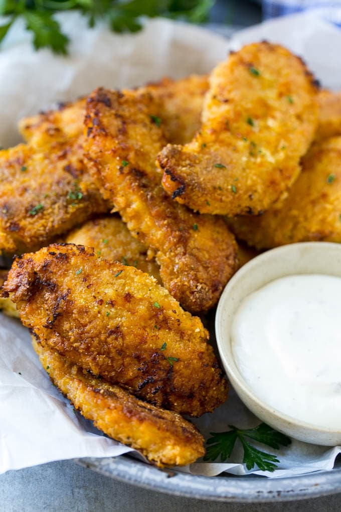 Baked Fried Chicken Recipe | Oven Fried Chicken | Baked Chicken Fingers | Crispy Chicken Fingers #chicken #friedchicken #bakedchicken #ovenfriedchicken #chickenfingers #dinner #bajap Crispy baked fried chicken fingers on a plate with ranch dip.