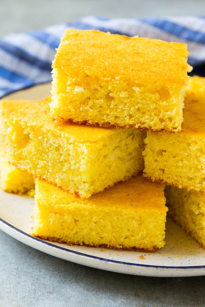 Honey Cornbread Recipe | Buttermilk Cornbread | Easy Cornbread | Homemade Cornbread | Cast Iron Cornbread #cornbread #honey #buttermilk #bread #bajap A plate full of squares of bread made with cornmeal.
