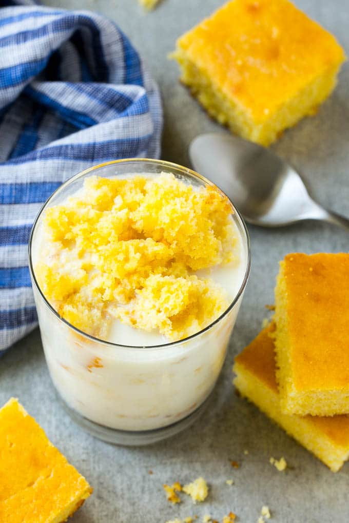 Honey Cornbread Recipe | Buttermilk Cornbread | Easy Cornbread | Homemade Cornbread | Cast Iron Cornbread #cornbread #honey #buttermilk #bread #bajap A glass of milk with cornbread crumbled into it.