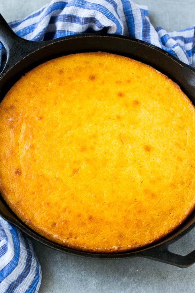 Honey Cornbread Recipe | Buttermilk Cornbread | Easy Cornbread | Homemade Cornbread | Cast Iron Cornbread #cornbread #honey #buttermilk #bread #bajap A cast iron pan of honey cornbread.