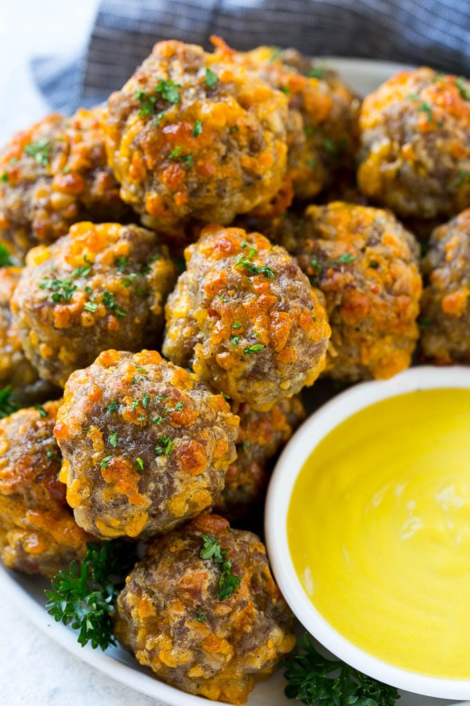 Sausage Cheese Balls Recipe | Sausage Balls Recipe | Bisquick Sausage Balls #sausage #sausageballs #balls #appetizer #cheeseballs #bajap A platter of sausage cheese balls with honey mustard sauce for dipping.