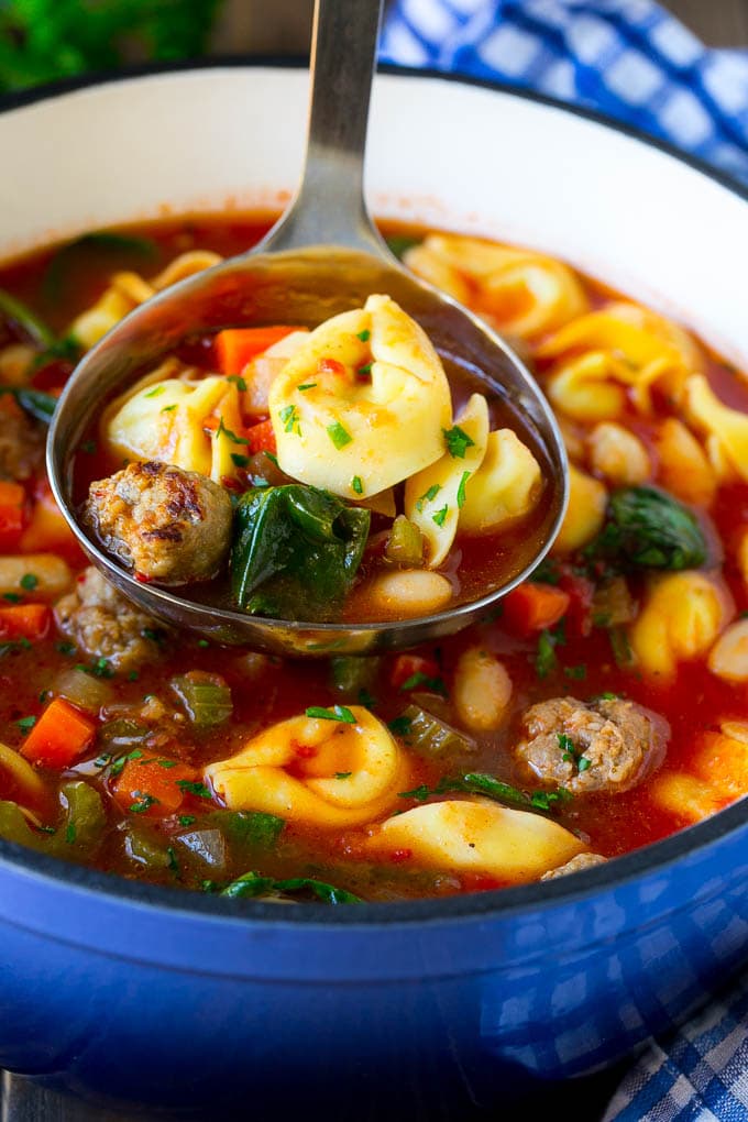 Tortellini Soup Recipe | Sausage Soup | Italian Soup #soup #sausage #pasta #tortellini #dinner #bajap A ladle serving up a portion of tortellini soup.