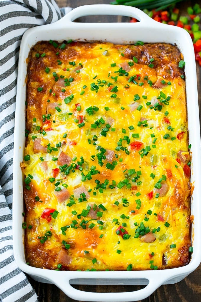 Hash Brown Egg Casserole Recipe | Breakfast Casserole with Ham | Hash Brown Casserole | Ham and Egg Casserole | Egg Casserole with Ham #casserole #breakfast #eggs #egg #hashbrown #bajap Hash brown egg casserole in a white baking dish.