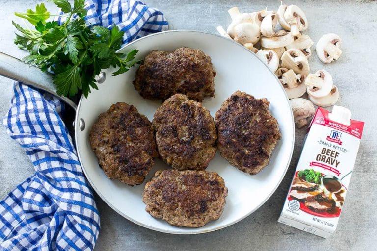 Slow Cooker Salisbury Steak Recipe | Homemade Salisbury Steak | Salisbury Steak from Scratch #steak #beef #salisbury #salisburysteak #slowcooker #crockpot #dinner #bajap Hamburger patties browned in a skillet.
