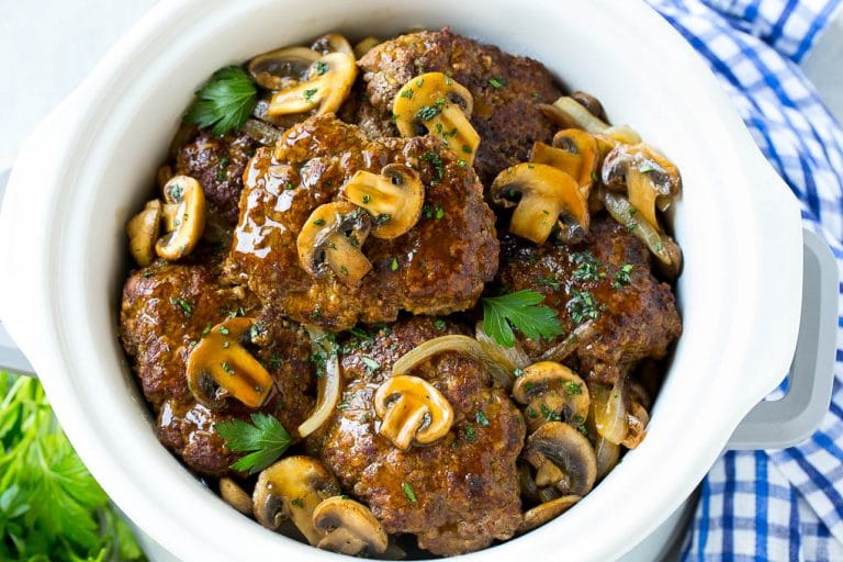 Slow Cooker Salisbury Steak Recipe | Homemade Salisbury Steak | Salisbury Steak from Scratch #steak #beef #salisbury #salisburysteak #slowcooker #crockpot #dinner #bajap A crock pot full of slow cooker salisbury steak.