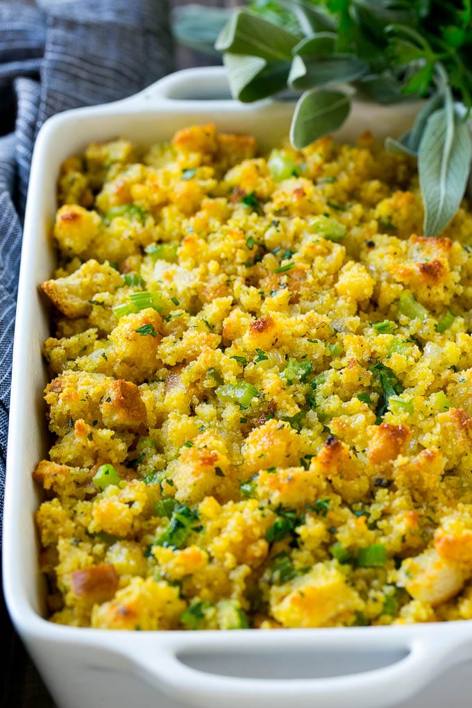 This old fashioned Southern cornbread dressing recipe is a classic that's a must-have for every Thanksgiving table. It's made with celery, onions, homemade cornbread, white bread and plenty of herbs. Southern Cornbread Dressing in a baking dish topped with chopped parsley.