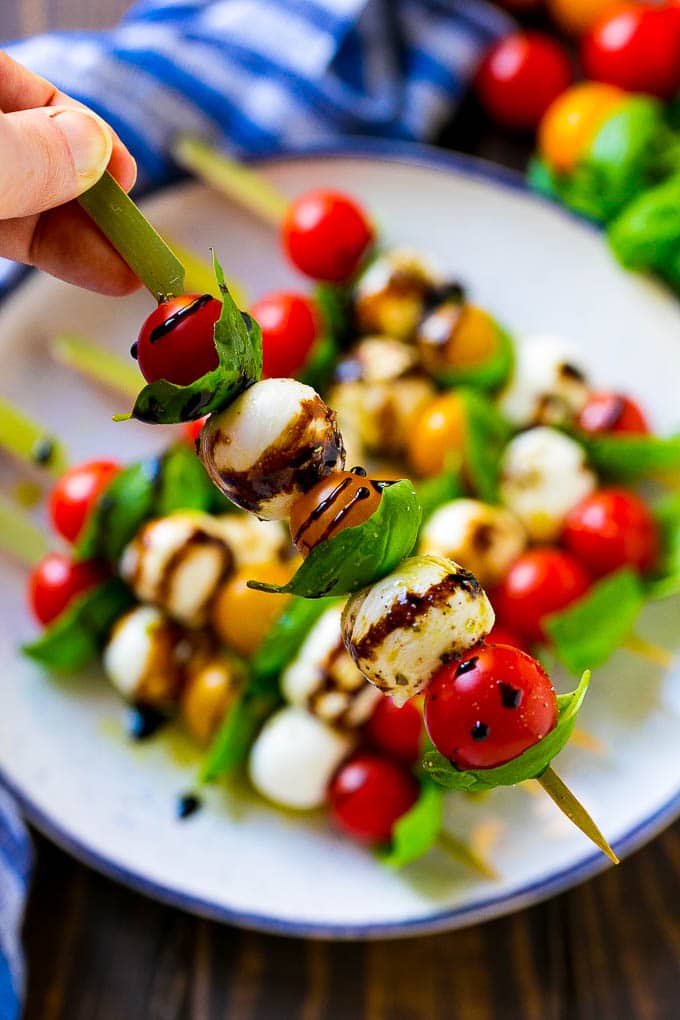 Caprese Skewers | Caprese Kabobs | Caprese Appetizer #tomato #mozzarella #basil #caprese #appetizer #bajap A kabob of mozzarella, tomatoes and basil drizzled with balsamic glaze.