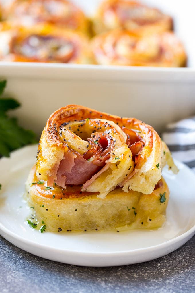 Ham and Cheese Pinwheels Recipe | Ham and Cheese Roll Ups | Ham and Cheese Rolls | Ham and Cheese Bread Rolls #ham #cheese #appetizer #pinwheels #bajap Ham and cheese pinwheels stacked on a serving plate.