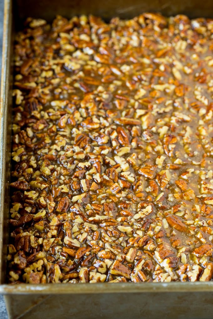 Pecan Pie Bars Recipe #pecans #pie #fall #pecanpie #dessert #thanksgiving #bajap Pecans and brown sugar poured over a cookie crust.
