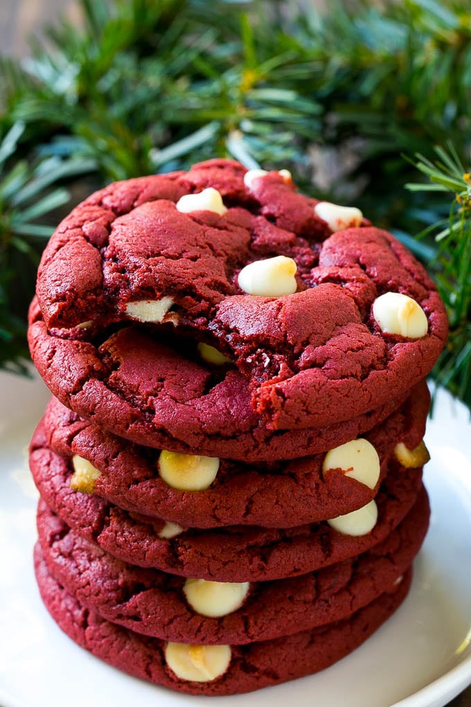 Red Velvet Cookies Recipe | Red Velvet Cookies with White Chocolate Chips | Red Velvet Cake Mix Cookies #redvelvet #cookies #whitechocolate #christmas #bajap A stack of red velvet cookies on a plate.
