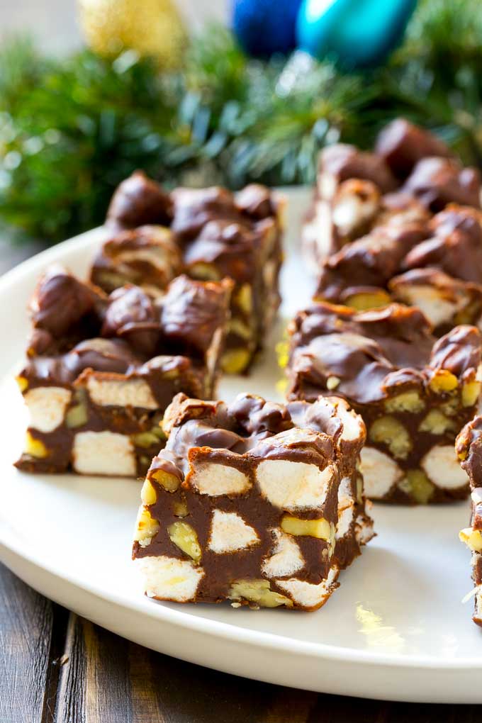 Rocky Road Fudge | Chocolate Marshmallow Fudge | Chocolate Nut Fudge | Microwave Fudge #fudge #chocolatefudge #nobake #chocolate #dessert #rockyroad #bajap Squares of rocky road fudge on a serving plate.