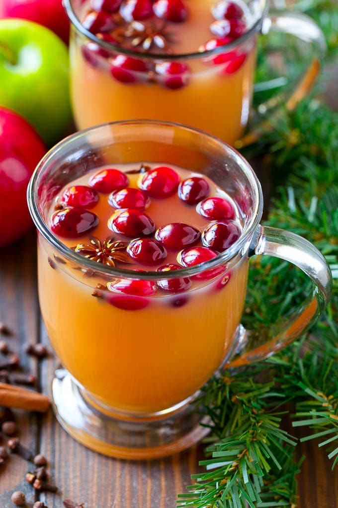 Slow Cooker Apple Cider | Mulled Apple Cider | Crockpot Apple Cider #cider #apple #applecider #drink #crockpot #slowcooker #bajap Mugs of slow cooker apple cider garnished with cranberries.