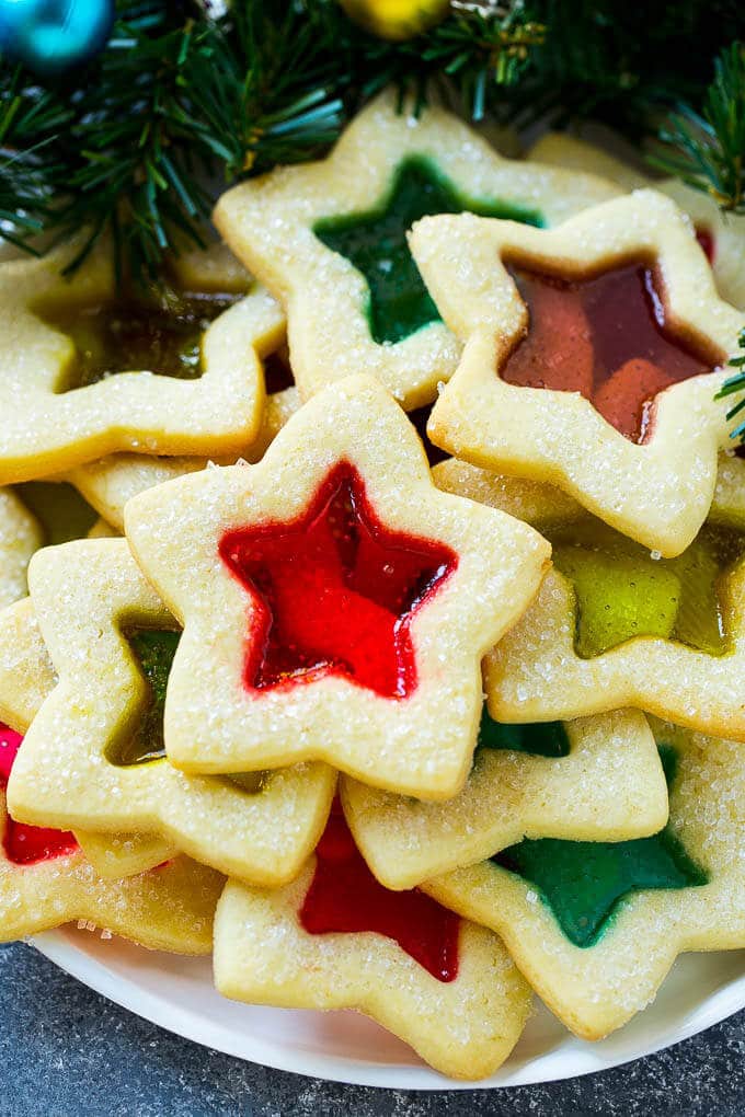 Stained Glass Cookies | Stained Glass Window Cookies | Christmas Cookies | Sugar Cookies | Holiday Cookies #cookies #stainedglasscookies #sugarcookies #christmascookies #christmas #holiday #dessert #bajap Stained glass cookies filled with melted candy and sprinkled with sugar.