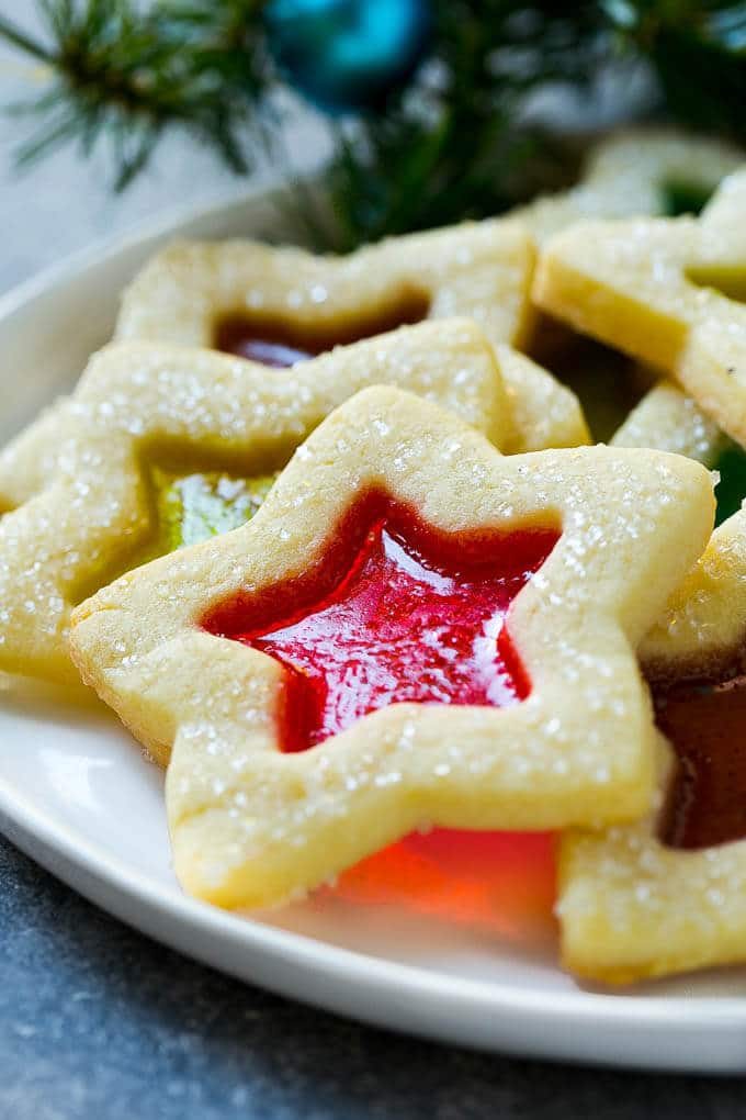 Stained Glass Cookies | Stained Glass Window Cookies | Christmas Cookies | Sugar Cookies | Holiday Cookies #cookies #stainedglasscookies #sugarcookies #christmascookies #christmas #holiday #dessert #bajap A star shaped cookie on a serving plate.