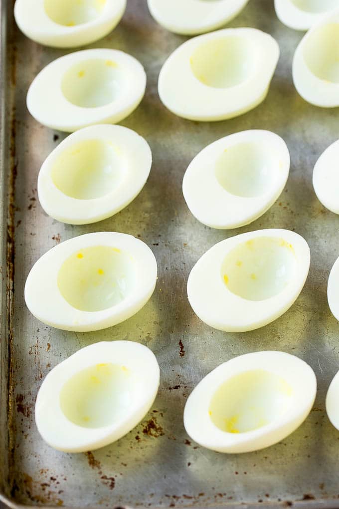 Bacon Deviled Eggs | Deviled Eggs Recipe #eggs #keto #lowcarb #bacon #appetizer #bajap Egg white halves on a sheet pan.