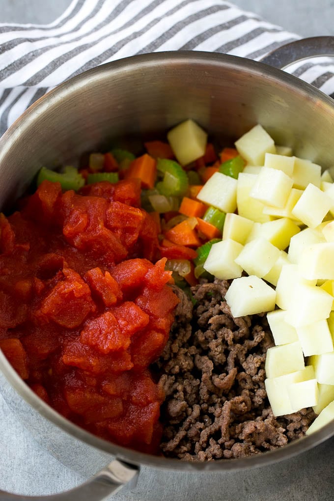 Hamburger Soup Recipe | Hamburger Stew | Ground Beef Soup #hamburger #soup #groundbeef #stew #dinner #bajap Potatoes and tomatoes go into hamburger soup before the pot comes to a simmer.