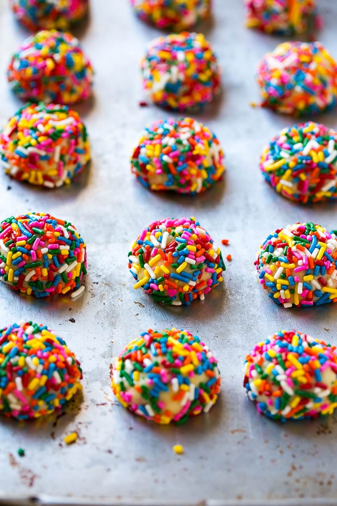 Funfetti Cookies Recipe | Funfetti Cake Mix Cookies | Sprinkle Cookies | Cake Mix Cookies #cookies #funfetti #sprinkles #dessert #bajap Balls of cookie dough coated in sprinkles.