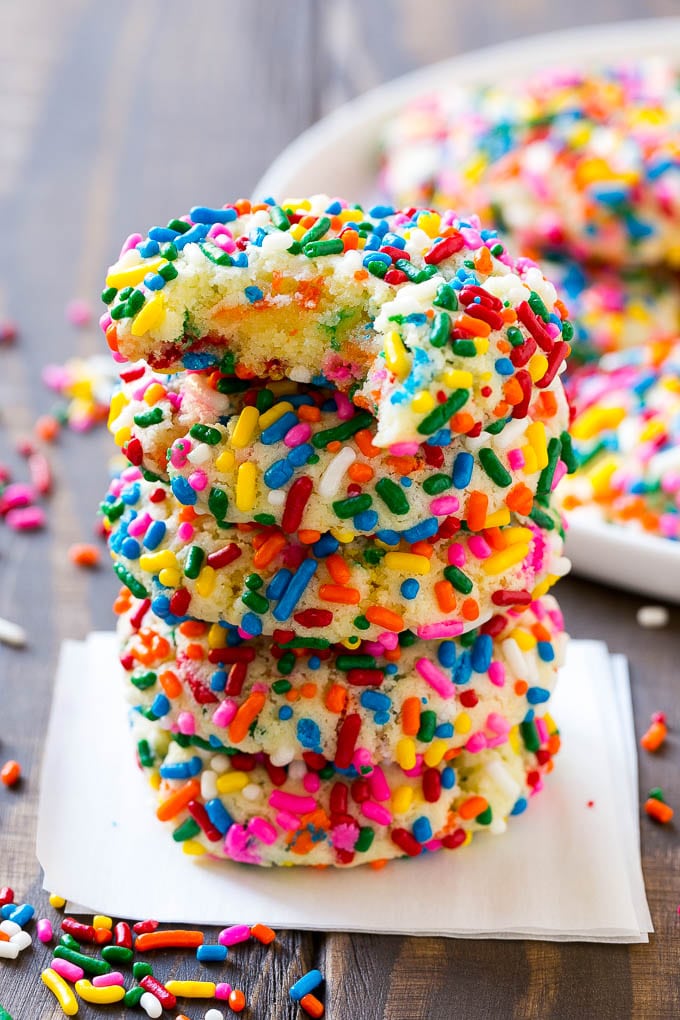 Funfetti Cookies Recipe | Funfetti Cake Mix Cookies | Sprinkle Cookies | Cake Mix Cookies #cookies #funfetti #sprinkles #dessert #bajap A stack of funfetti cookies with a bite taken out of one.