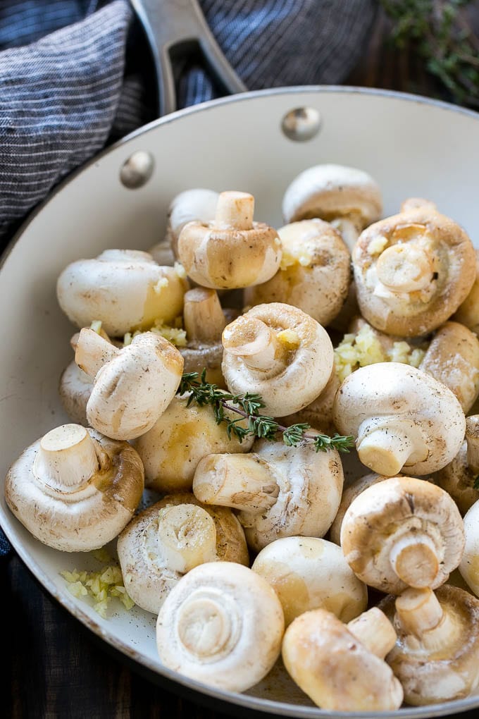 Garlic Mushrooms Recipe | Steakhouse Mushrooms | Sauteed Mushrooms | Garlic Butter Mushrooms | Mushroom Side Dish #mushrooms #butter #keto #lowcarb #dinner #sidedish #bajap Uncooked buttons with herbs and butter in a frying pan.