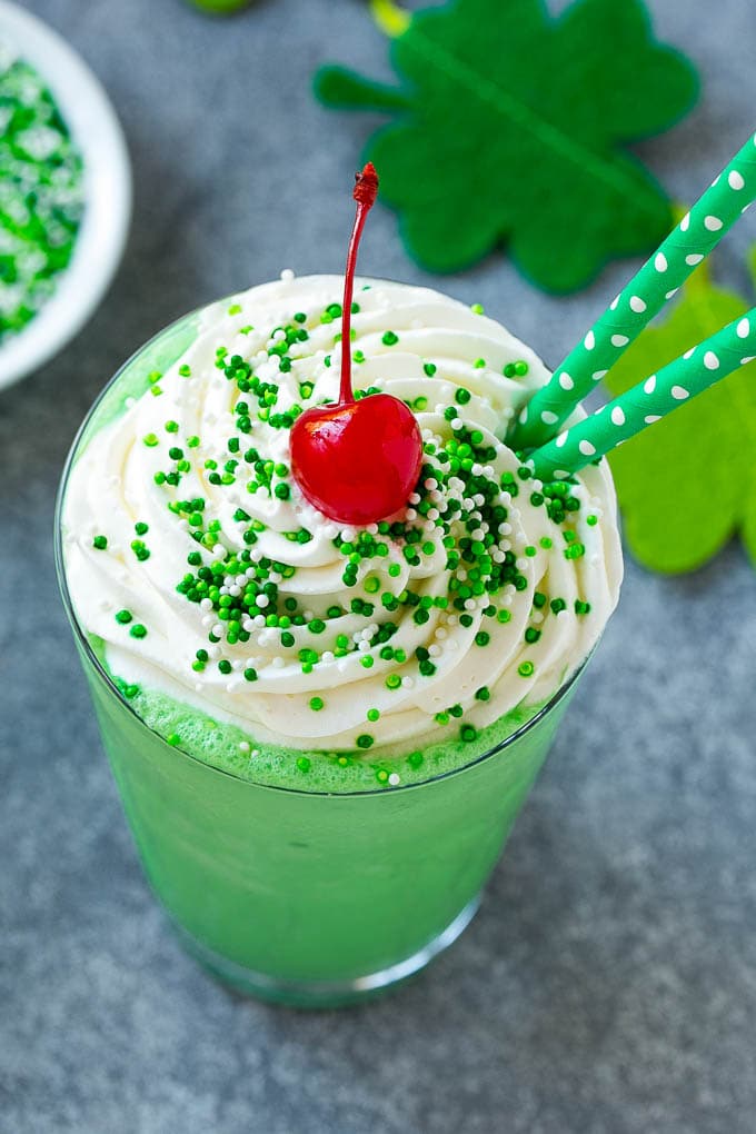 Shamrock Shake Recipe | McDonald's Shamrock Shake | Saint Patrick's Day Drink | Mint Milkshake #milkshake #stpatricksday #saintpatricksday #mint #bajap A mint Shamrock shake finished off with a swirl of whipped cream sprinkles and a cherry.
