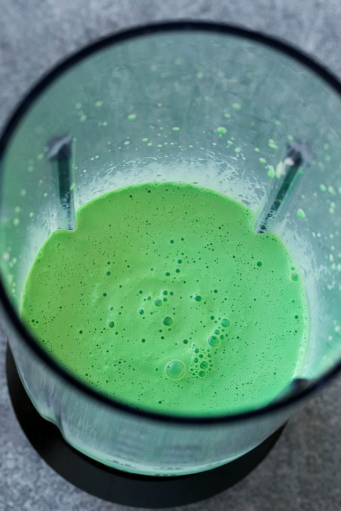 Shamrock Shake Recipe | McDonald's Shamrock Shake | Saint Patrick's Day Drink | Mint Milkshake #milkshake #stpatricksday #saintpatricksday #mint #bajap Green milkshake in a blender.
