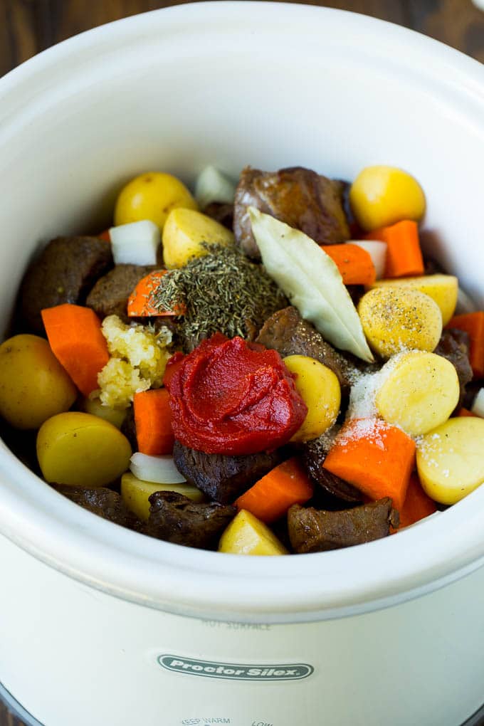 Slow Cooker Beef Stew Recipe | Crockpot Beef Stew #stew #soup #beef #slowcooker #crockpot #dinner #bajap A crock pot filled with beef, vegetables, tomato paste, herbs and spices.
