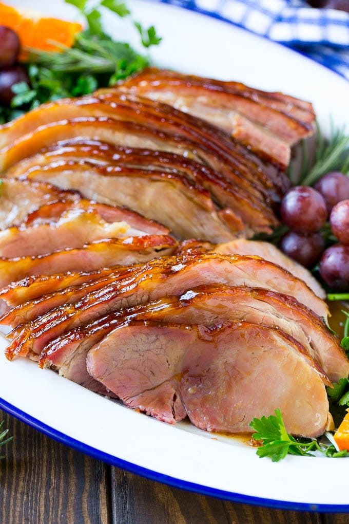 Coca Cola Ham | Coke Glazed Ham | Easter Ham | Christmas Ham | Holiday Ham Recipe #ham #easter #christmas #dinner #bajap A platter of sliced coca cola ham with herbs.