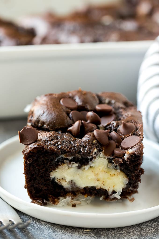 Earthquake Cake Recipe | Chocolate Cake Recipe | Chocolate Coconut Cake | Coconut Pecan Cake #cake #chocolate #coconut #pecans #dessert #chocolatecake #bajap A slice of earthquake cake on a plate.
