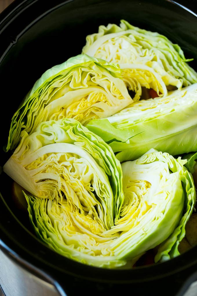 Slow Cooker Corned Beef Recipe | Crock Pot Corned Beef | Corned Beef and Cabbage #beef #cornedbeef #cabbage #potatoes #carrots #stpatricksday #irish #bajap Cabbage wedges inside a crock pot.