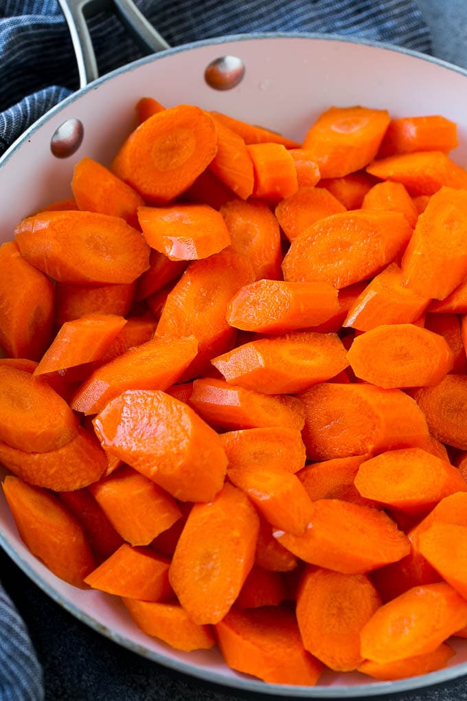 Candied Carrots Recipe | Carrot Side Dish | Brown Sugar Carrots | Glazed Carrots #carrots #brownsugar #sidedish #dinner #bajap Raw sliced carrots in a pan.
