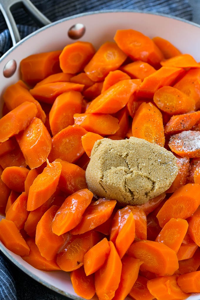 Candied Carrots Recipe | Carrot Side Dish | Brown Sugar Carrots | Glazed Carrots #carrots #brownsugar #sidedish #dinner #bajap Sliced carrots with butter, brown sugar and seasonings in a pan.