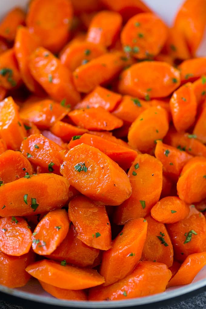 Candied Carrots Recipe | Carrot Side Dish | Brown Sugar Carrots | Glazed Carrots #carrots #brownsugar #sidedish #dinner #bajap A close up of cooked candied carrots topped with parsley.
