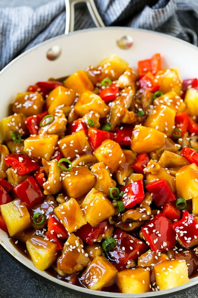 Pineapple Chicken | Hawaiian Chicken | Chicken Stir Fry #pineapple #chicken #dinner #stirfry #bajap Pineapple chicken stir fry in a skillet, topped with sauce, sesame seeds and green onions.