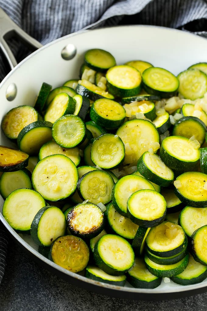 Zucchini Gratin Recipe | Cheesy Zucchini | Baked Zucchini | Easy Zucchini Recipe #zucchini #casserole #cheese #dinner #sidedish #bajap Sauteed zucchini and onions in a skillet.