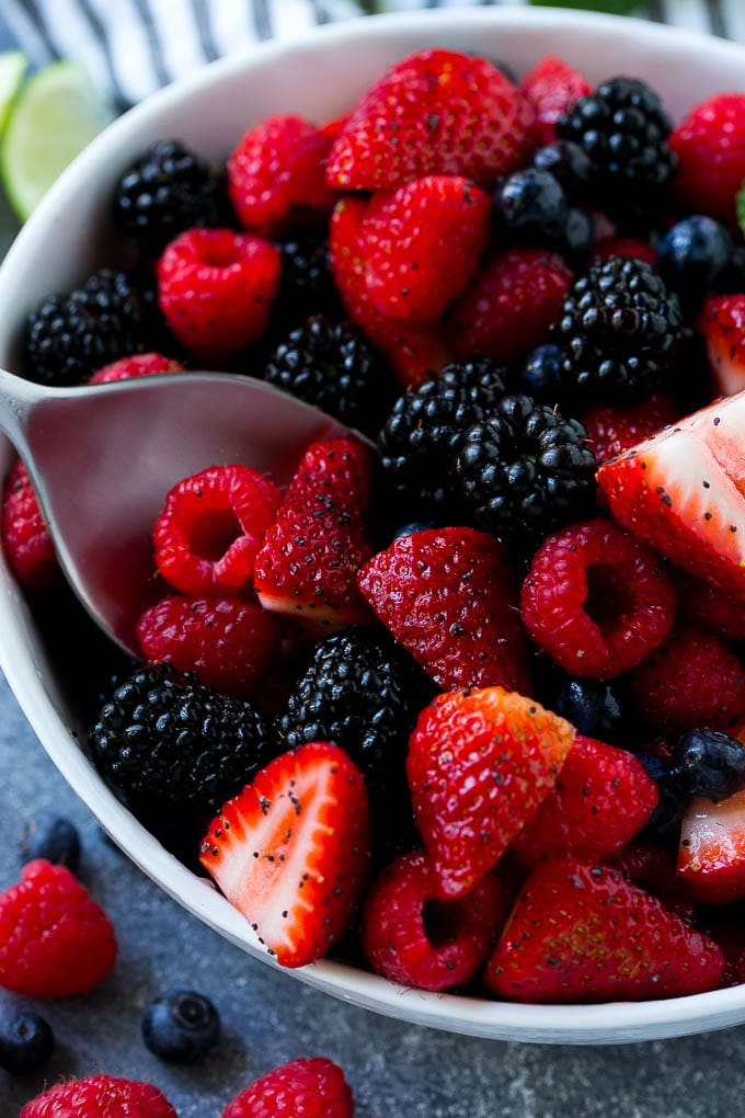 Berry Fruit Salad Recipe | Berry Salad | Summer Berry Salad | Fruit Salad Recipe #berries #fruitsalad #bajap A bowl of berry fruit salad with a serving spoon in it.