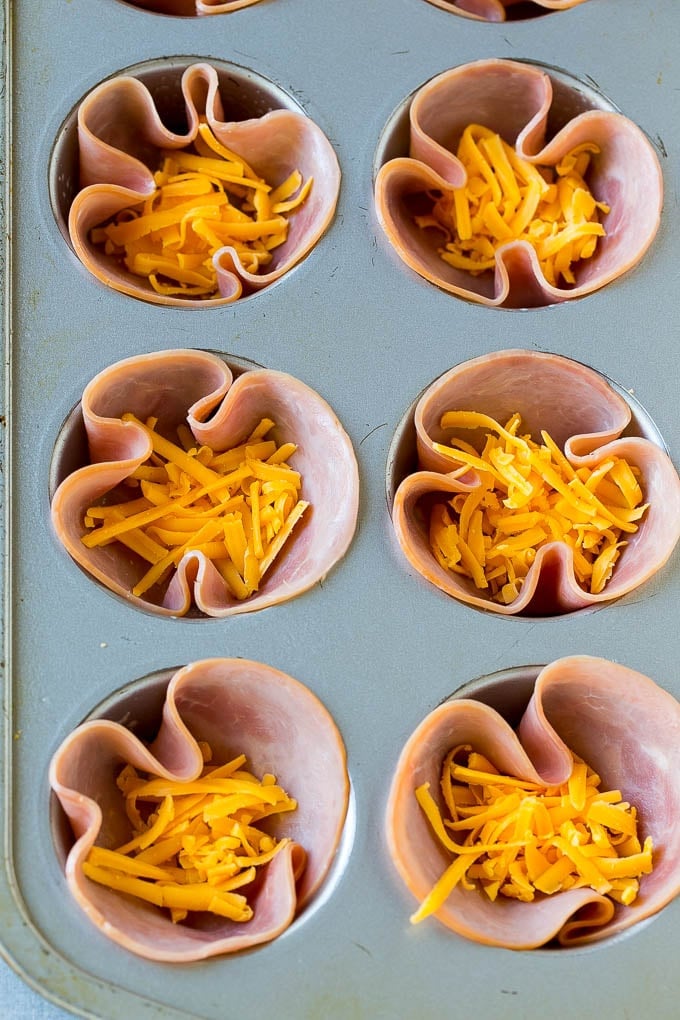 Ham and Egg Cups Recipe | Low Carb Breakfast | Ham and Eggs #ham #eggs #lowcarb #breakfast #bajap Ham pressed into muffin tins and topped with shredded cheese.