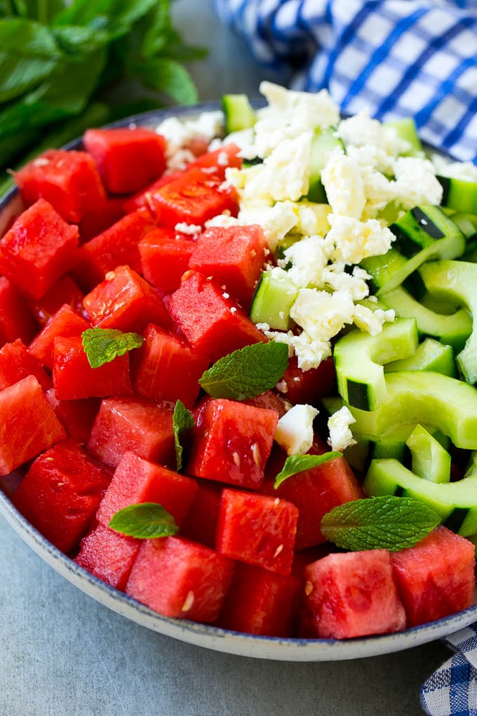 Watermelon Salad Recipe | Watermelon Feta Salad | Watermelon Cucumber Salad #watermelon #cucumber #salad #bajap A bowl of watermelon, cucumber, feta cheese and mint leaves drizzled with lime dressing.