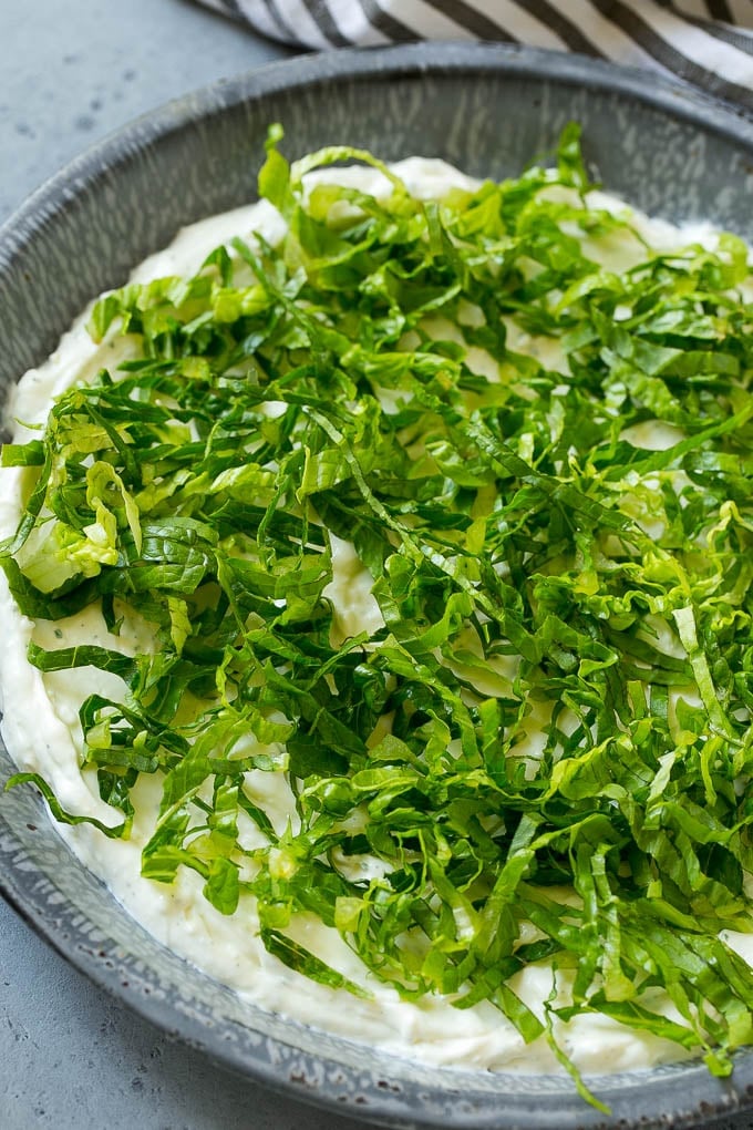 BLT Dip Recipe | Bacon Dip Recipe | Ranch Dip #dip #ranch #bacon #lettuce #tomato #appetizer #bajap Shredded romaine lettuce over a sour cream, cream cheese and ranch powder base.