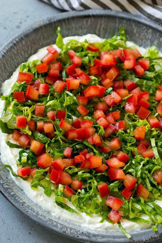 BLT Dip Recipe | Bacon Dip Recipe | Ranch Dip #dip #ranch #bacon #lettuce #tomato #appetizer #bajap Lettuce and tomatoes on top of ranch dip.