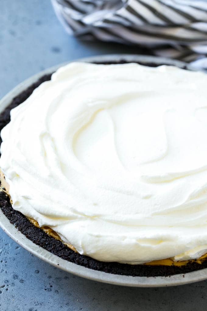 Chocolate Peanut Butter Pie Recipe | Peanut Butter Cup Pie | Peanut Butter Pie | No Bake Pie #chocolate #peanutbutter #pie #nobake #dessert #bajap Whipped cream topping on top of a nut butter tart.