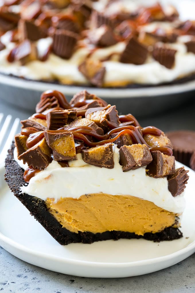 Chocolate Peanut Butter Pie Recipe | Peanut Butter Cup Pie | Peanut Butter Pie | No Bake Pie #chocolate #peanutbutter #pie #nobake #dessert #bajap A slice of chocolate peanut butter pie topped with whipped cream, chocolate sauce and peanut butter cups.
