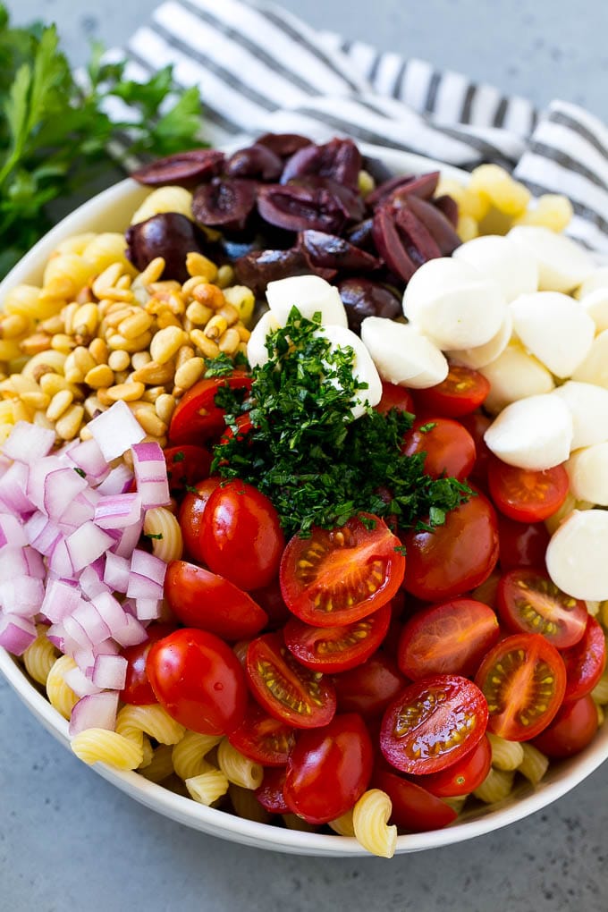 Pesto Pasta Salad | Italian Pasta Salad | Easy Pasta Salad #pasta #salad #pesto #olives #tomatoes #bajap Pasta with cherry tomatoes, mozzarella balls, kalamata olives, parsley and red onion.