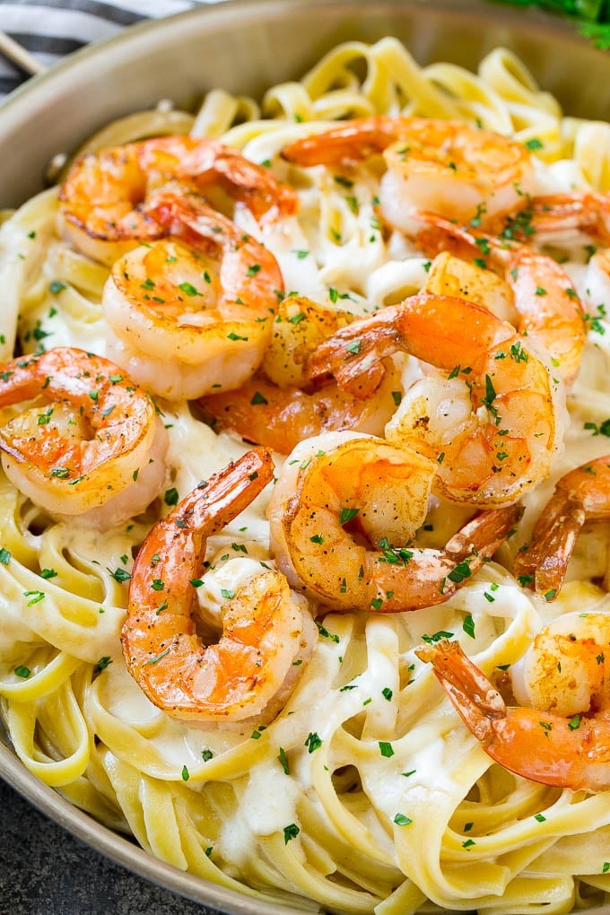 Shrimp Alfredo Recipe | Shrimp Alfredo Pasta | Shrimp Fettuccine Alfredo #shrimp #pasta #italianfood #bajap Shrimp alfredo in a skillet, topped with chopped parsley.