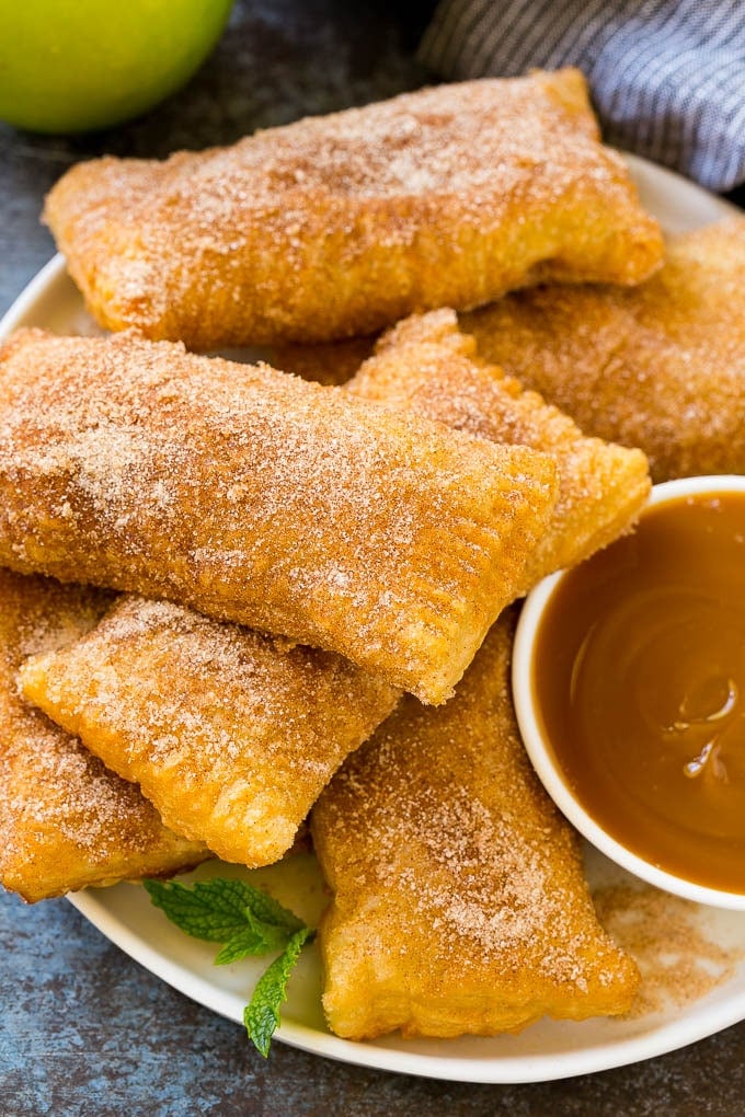 Fried Apple Pies Recipe | McDonald's Copycat Recipe | Apple Pie | Apple Hand Pies #pie #apples #applepie #dessert #snack #bajap A plate of deep fried apple pies dusted with cinnamon sugar.