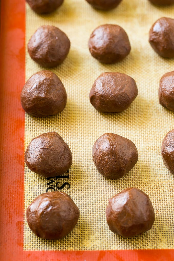 Nutella Cookies Recipe | Nutella Stuffed Cookies | Chocolate Cookies #nutella #chocolate #cookies #baking #dessert #bajap Balls of chocolate cookie dough on a baking sheet.