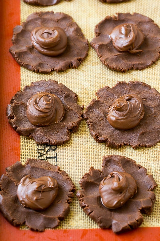 Nutella Cookies Recipe | Nutella Stuffed Cookies | Chocolate Cookies #nutella #chocolate #cookies #baking #dessert #bajap Cookie dough with dollops of nutella in the center.