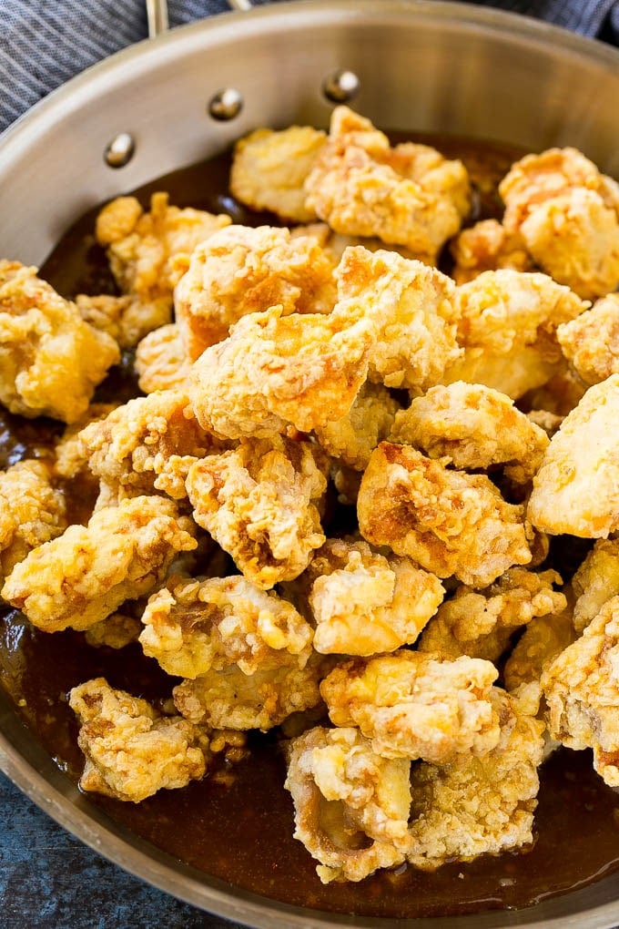 Orange Chicken Recipe | Chinese Orange Chicken | Panda Express Orange Chicken #orange #chicken #takeout #chinesefood #dinner #bajap Crispy chicken pieces in a pan of orange sauce.